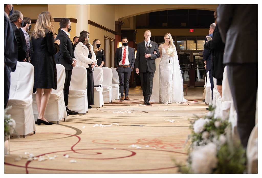wedding photographer captures bride down the aisle